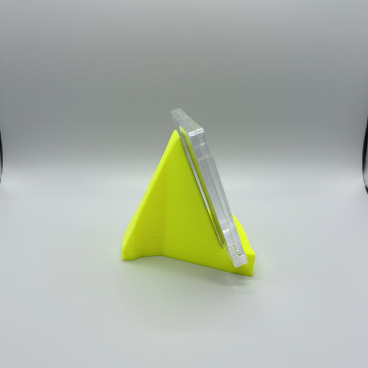 Small yellow funnel on a textured surface with a blurred background
