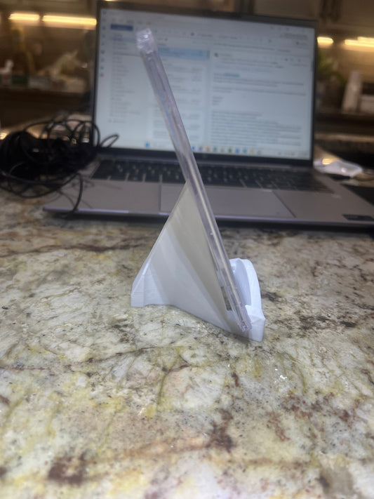 Laptop on a marble surface with a piece of paper on top