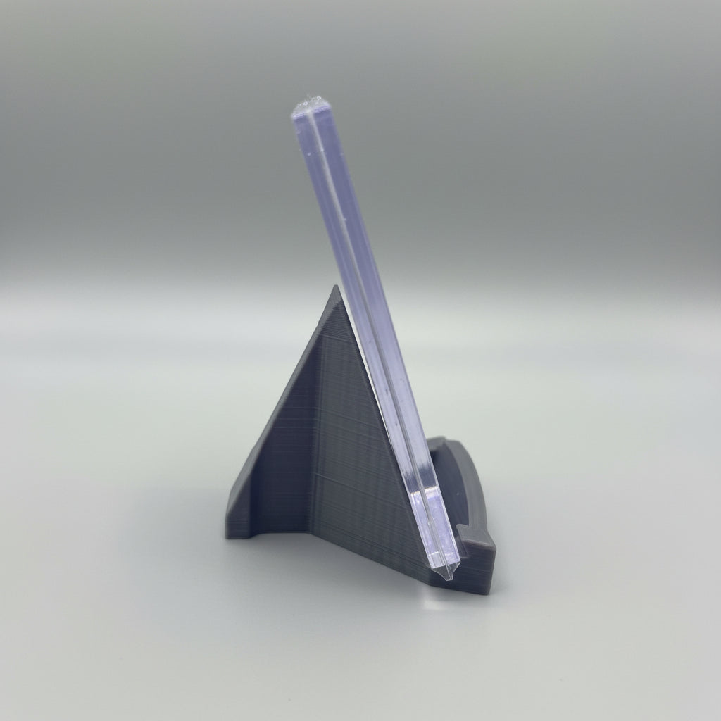 Clear plastic stand on a marble surface with a laptop in the background