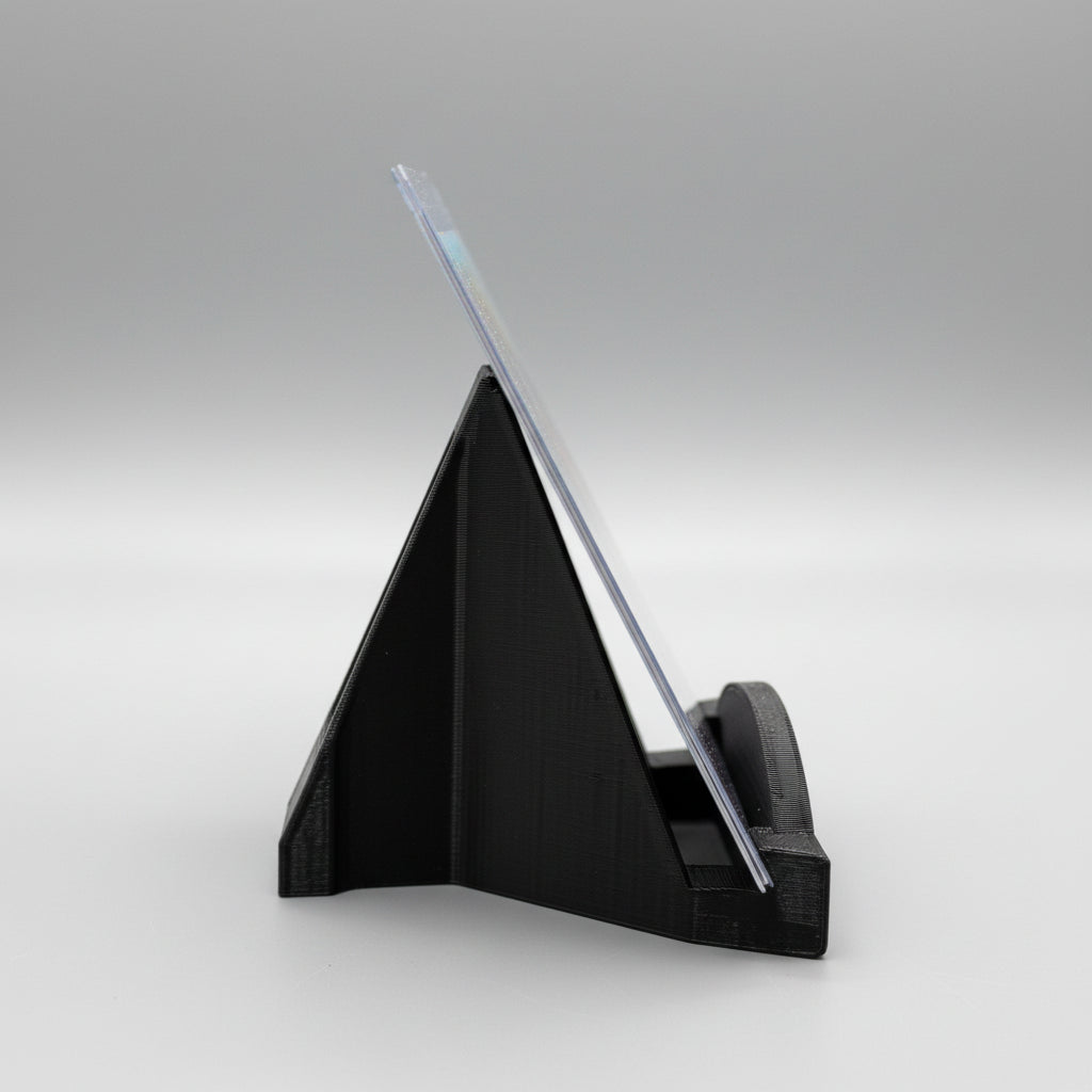 Black triangular stand with a clear acrylic panel on a wooden surface