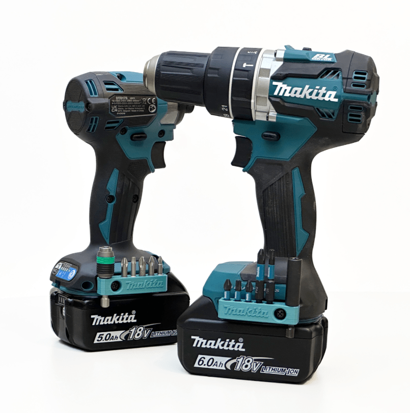 Two Makita cordless drills with batteries on a white background