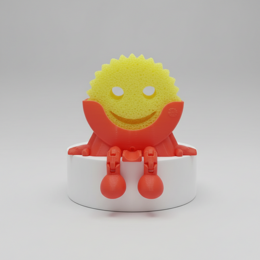 3D-printed character with a yellow face and red body on a white stand against a reflective surface.