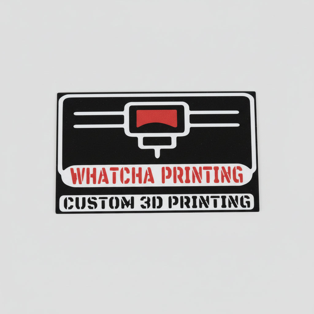 Sticker with 'Whatcha Printing' and 'Custom 3D Printing' text on a wooden surface