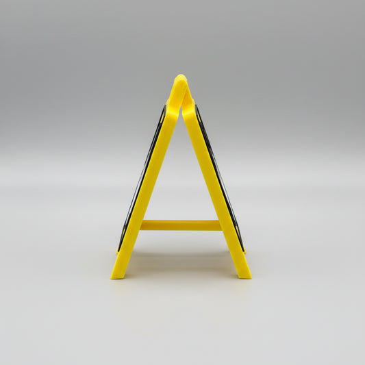 Yellow safety sign on a reflective surface