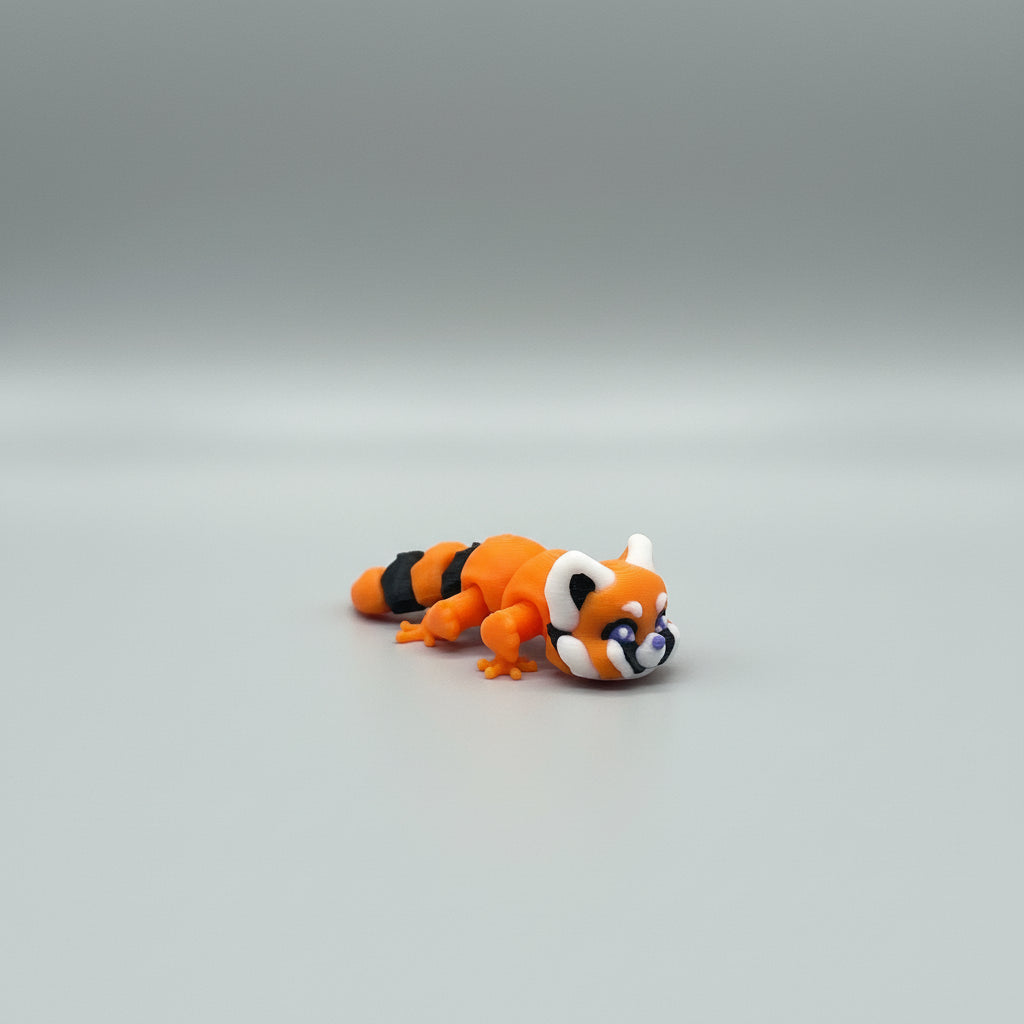 Orange and black toy caterpillar on brown branches with a textured background