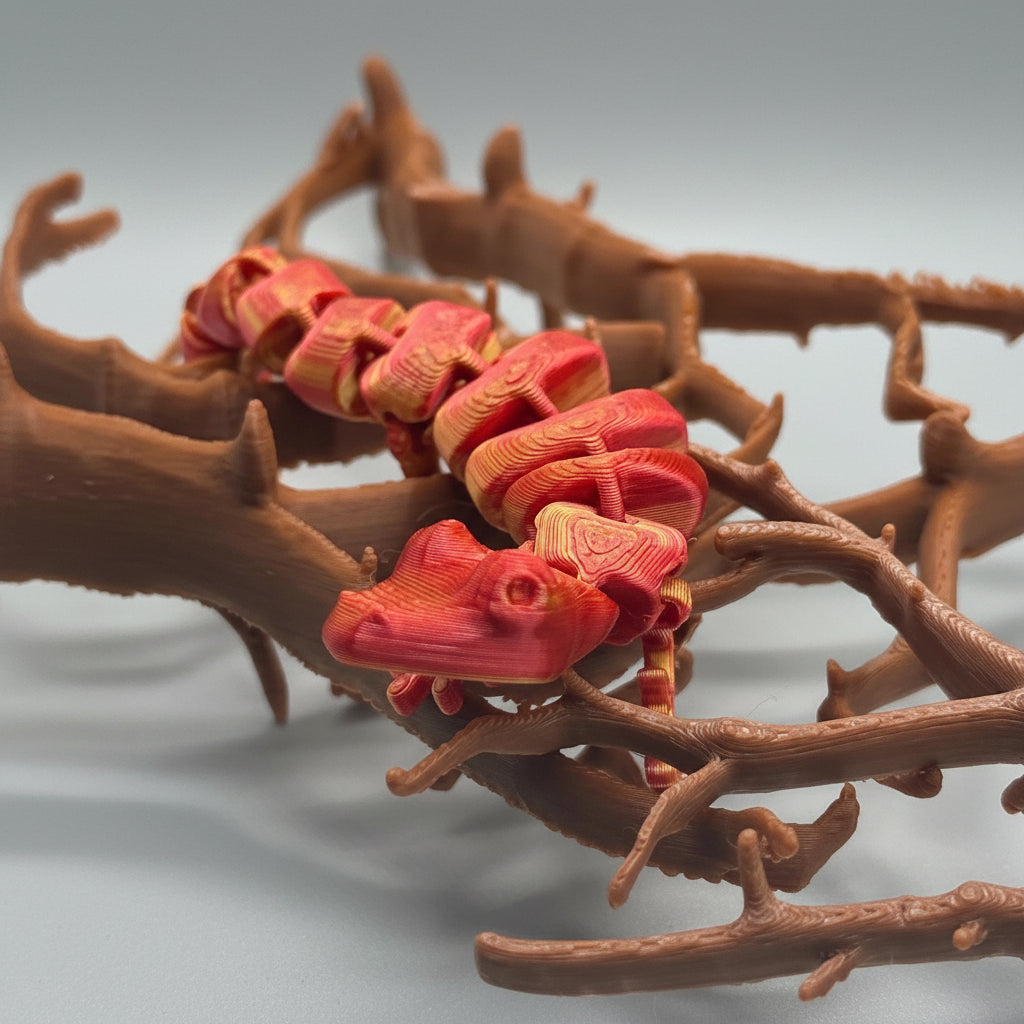 Red and brown snake-like figurine on a textured surface
