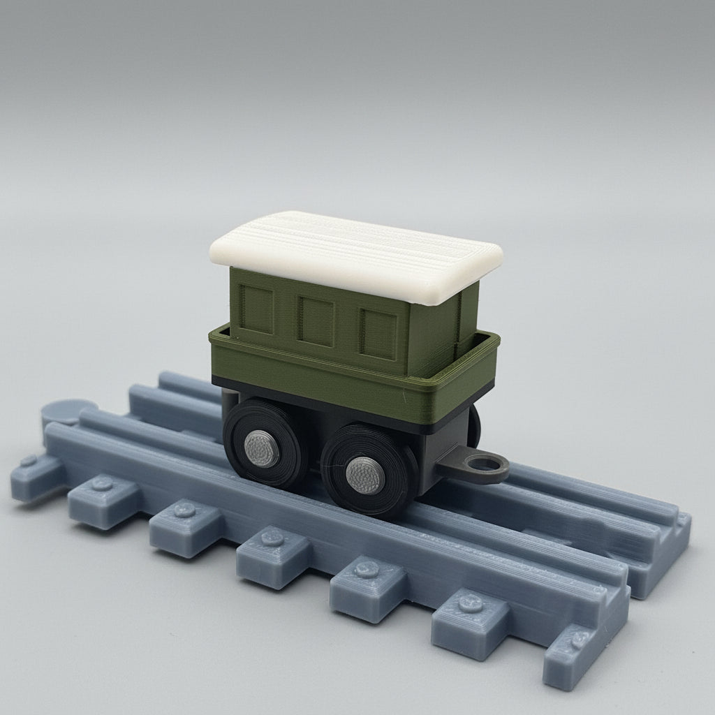 Toy train car with a white roof on a gray track against a textured background