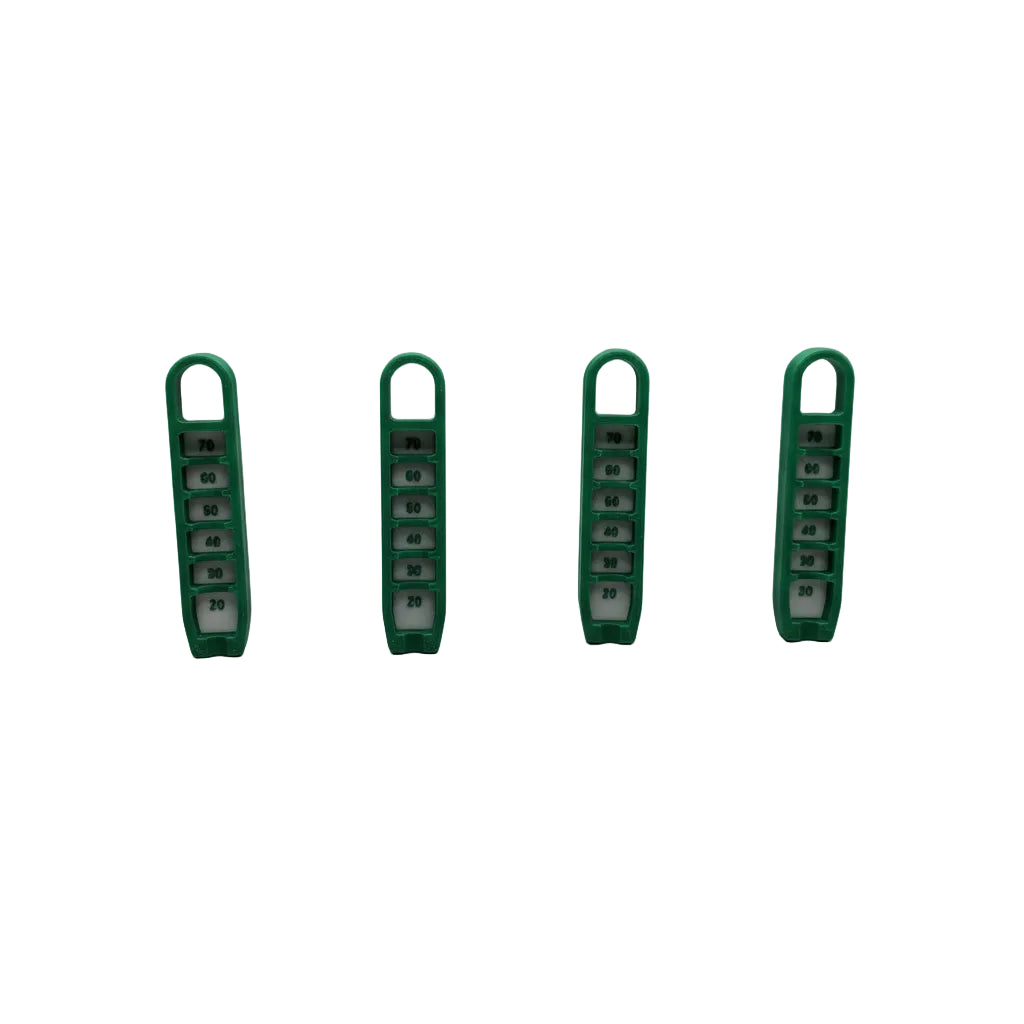 Four green plastic clips on a textured metallic surface