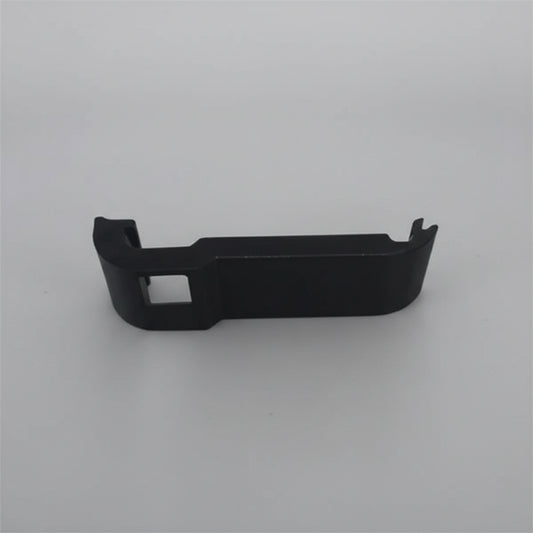 Black plastic component on a gray background