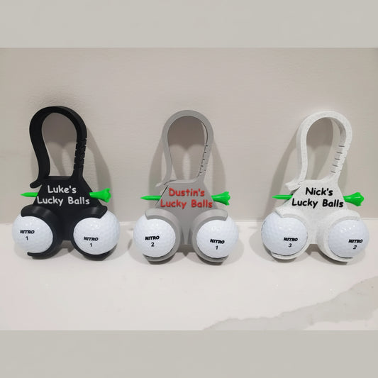 Three sets of golf balls with personalized holders on a white background