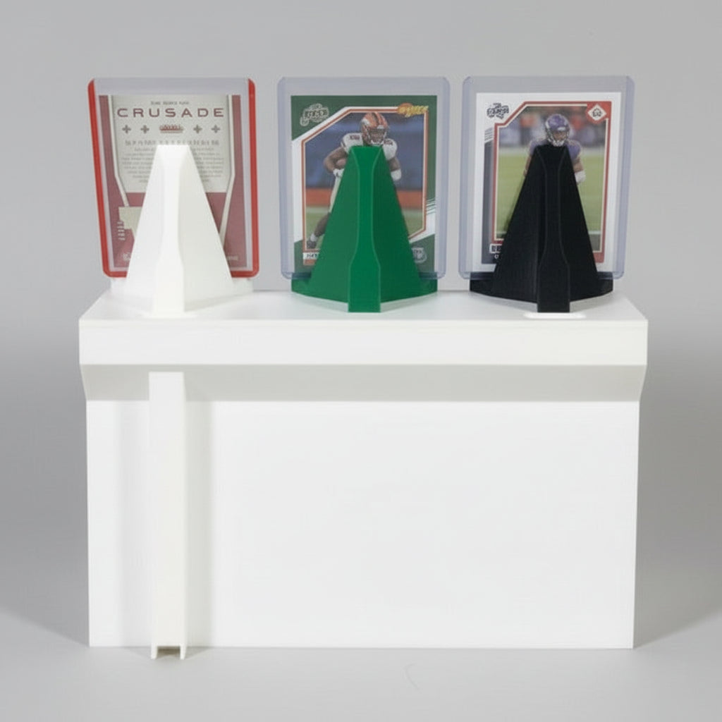 Three display stands in white, green, and black on a white surface with trading cards in the background.