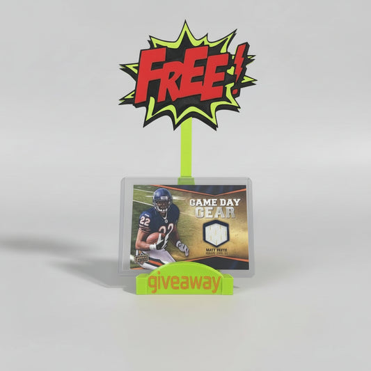 Trading card packaging with 'Free Giveaway' sign on a gray background