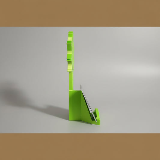 Green card holder with cards on a wooden surface