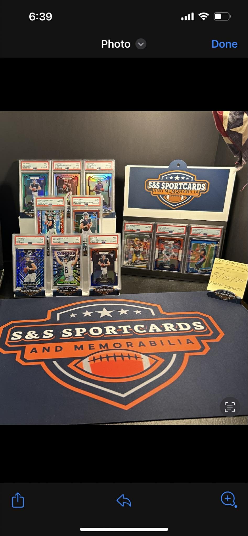 Collection of sports cards and memorabilia displayed on a table with 'S&S Sportcards and Memorabilia' branding.