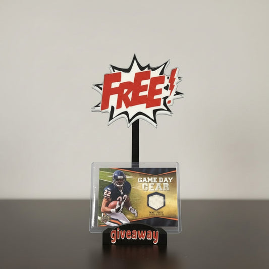 Promotional stand with 'FREE! Game Day Gear Giveaway' text and a sports trading card on a gray background.