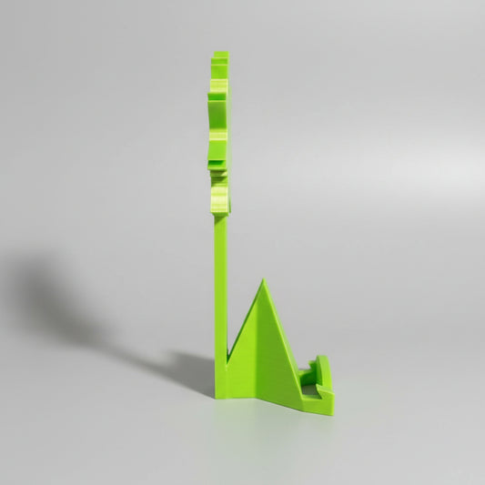 Green phone stand on a wooden surface with sports trading cards in the background