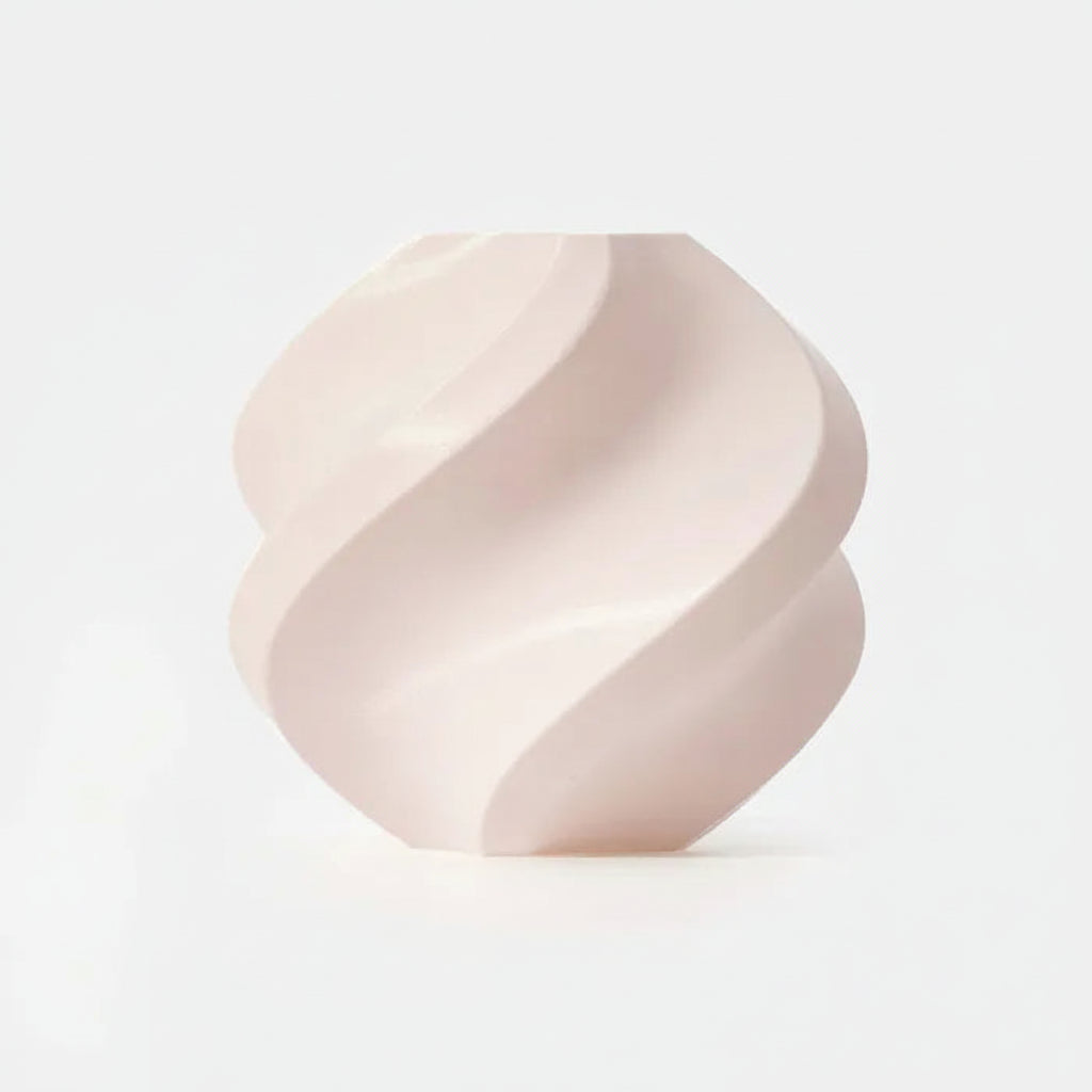 Pink ceramic vase with wavy design on a white background, featuring the RFID logo.