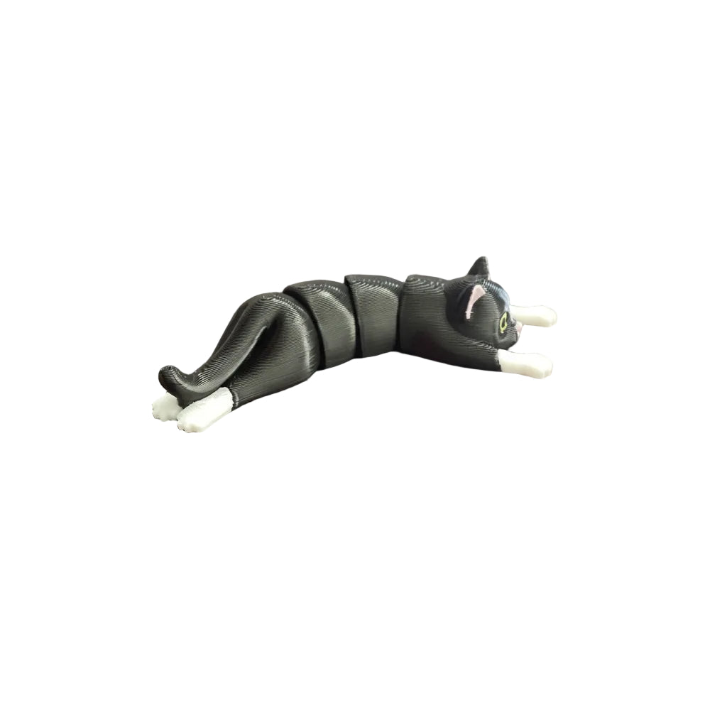 Black cat-shaped toy on a wooden surface