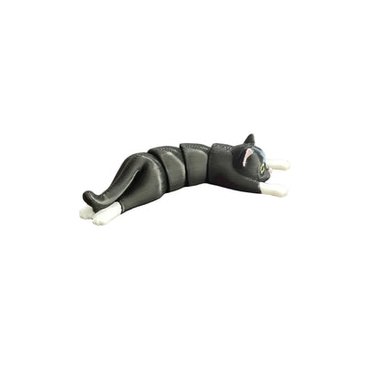 Black cat-shaped toy on a wooden surface
