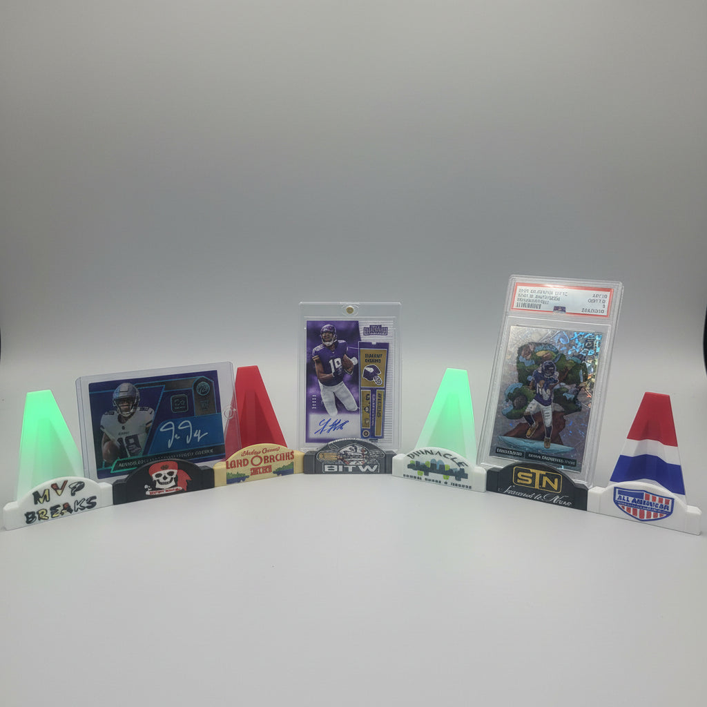 Collection of sports trading cards on a counter with a display of more cards in the background.