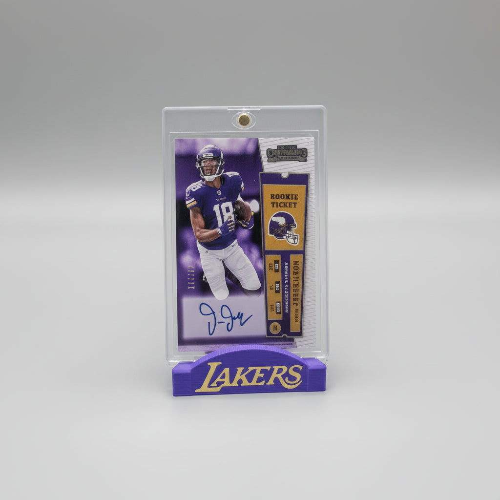 Collectible sports trading card in a clear holder on a surface with other cards in the background