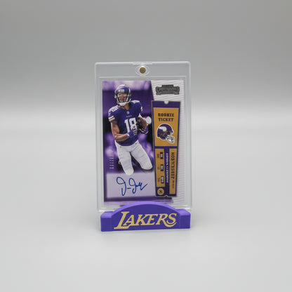 Collectible sports trading card in a clear holder on a surface with other cards in the background