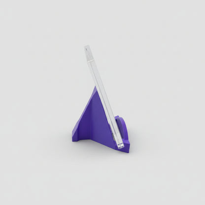 Purple triangular pen holder with a white pen on a light gray background