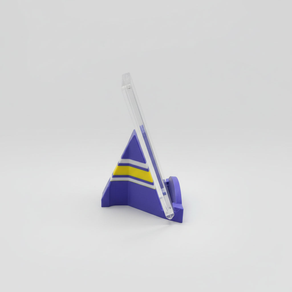Purple and yellow plastic model on a marble surface with a laptop in the background