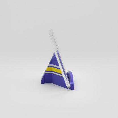 Purple and yellow plastic model on a marble surface with a laptop in the background