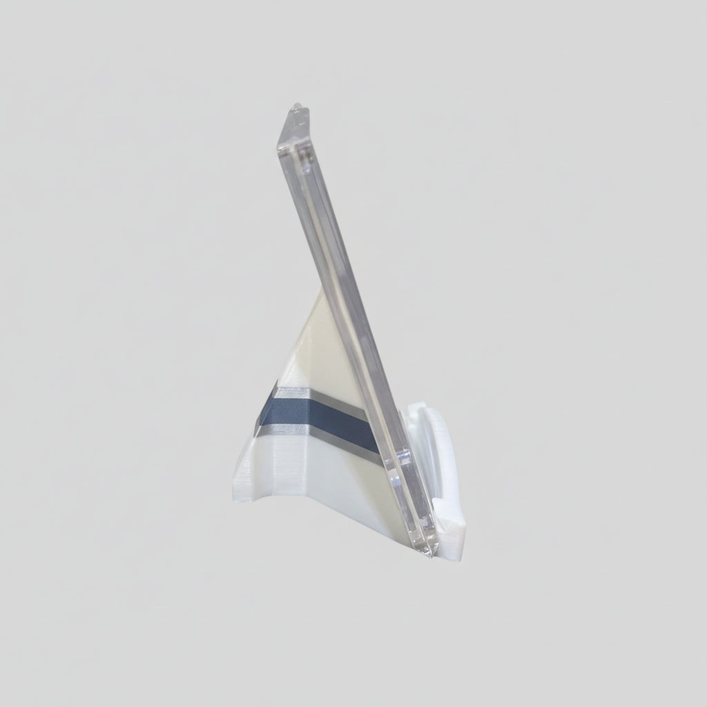 Clear plastic stand on a marble surface with a laptop in the background