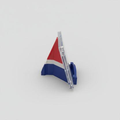 Pen with a 3D triangular flag design on a marble surface with a laptop in the background.