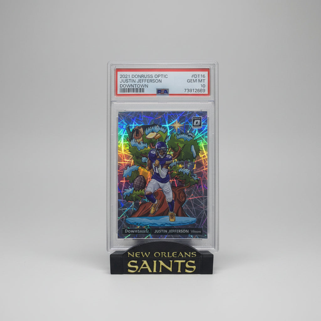 Trading card of a New Orleans Saints player in a reflective case with PSA certification on a marble surface.