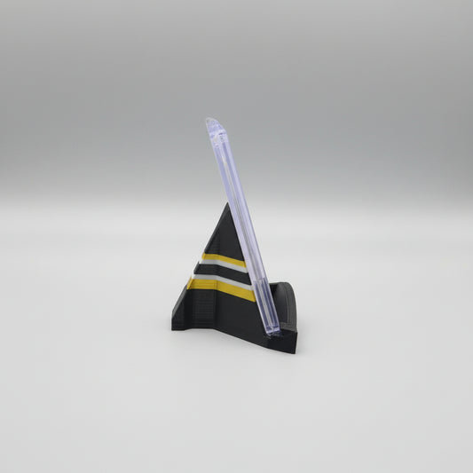 Model rocket on a marble surface with a laptop in the background