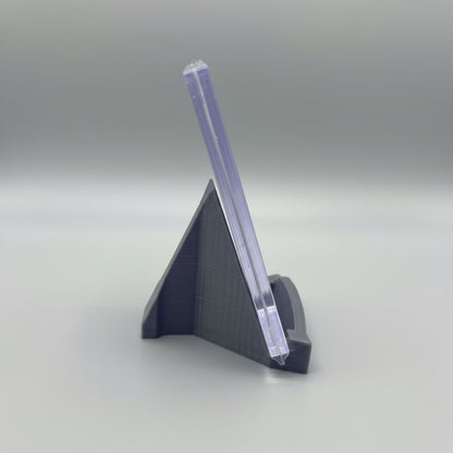 Clear plastic stand on a marble surface with a laptop in the background