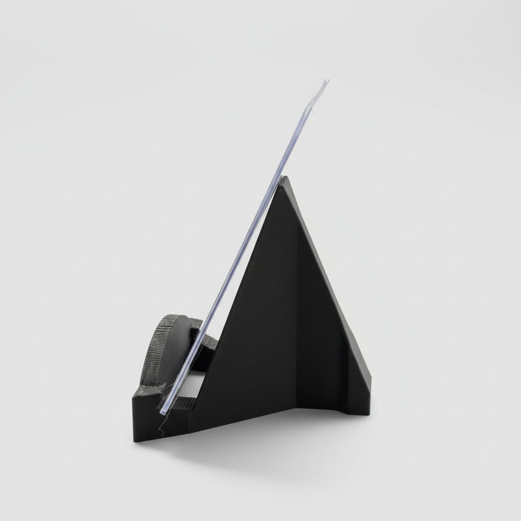 Black paper cutter on a desk with office supplies in the background