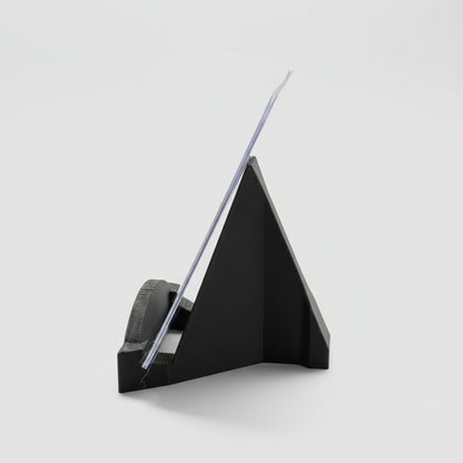 Black paper cutter on a desk with office supplies in the background