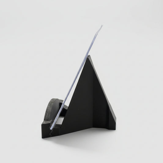 Black paper cutter on a desk with office supplies in the background