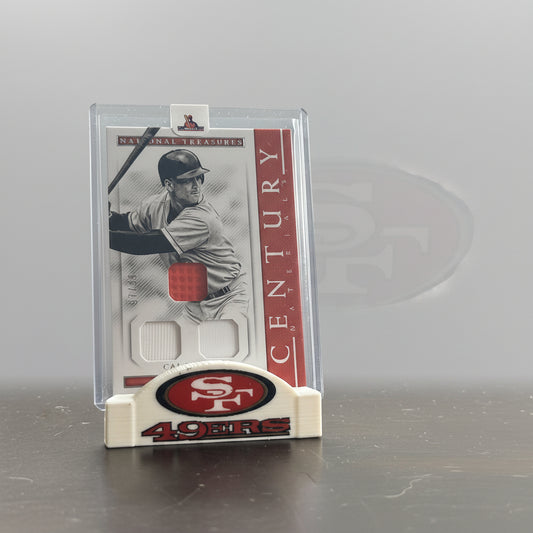 Baseball card in a holder with San Francisco 49ers logo in the background