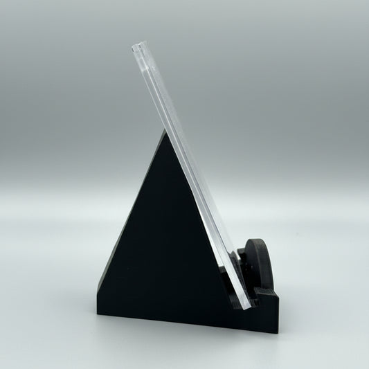 Clear ruler on a black stand against a metallic background