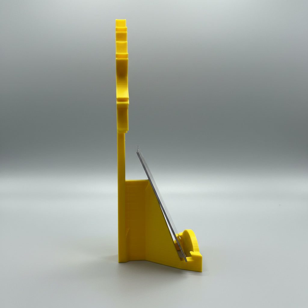 Yellow plastic tool on a metallic surface