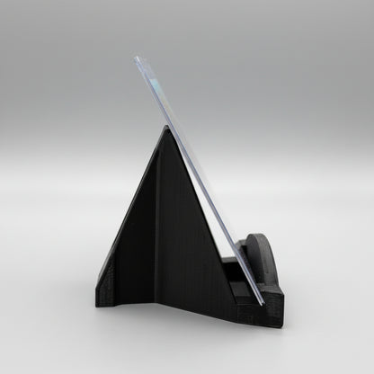 Black triangular stand with a clear acrylic panel on a wooden surface
