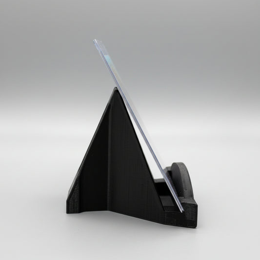 Black triangular stand with a clear acrylic panel on a wooden surface