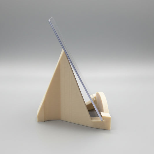 Clear plastic ruler on a beige stand against a dark surface