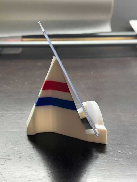 Triangular stand with a clear rod on a dark surface