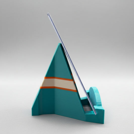 Teal sailboat model on a gray background