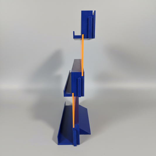 Blue plastic tool with orange accents on a dark surface