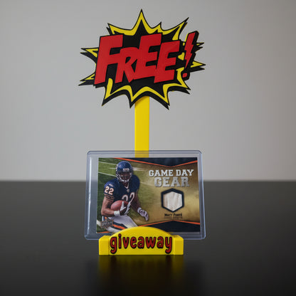 Promotional card holder with 'FREE! Giveaway' text and a football-themed card in front of a collection of sports cards.