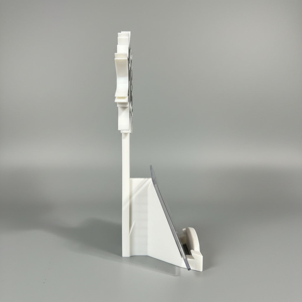 White plastic stand with a clear acrylic panel on a dark surface