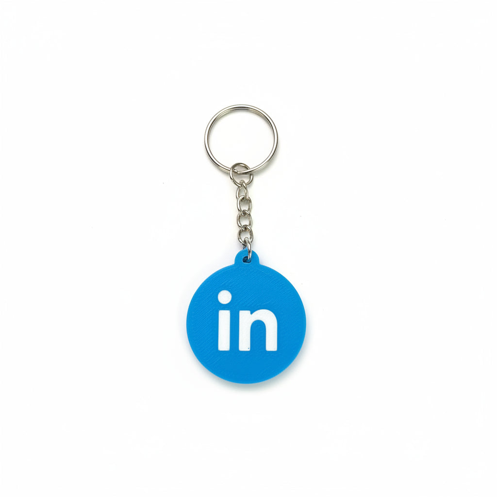 Blue keychain with LinkedIn logo on a textured black surface