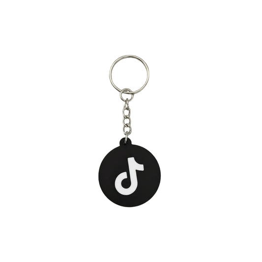 Black keychain with a white logo on a dark textured background